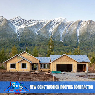 new home construction in front of a snow covered mountain