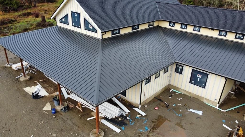 overhead shot of a two story building in WA with grey metal roofing mid-consturction